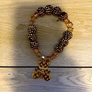 Beautiful brown bracelet with gold charm